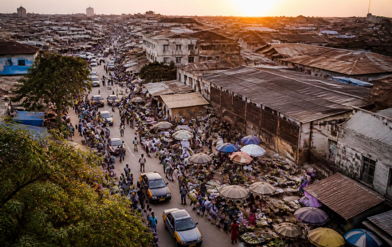 Aerial view of a busy West African city street at dawn